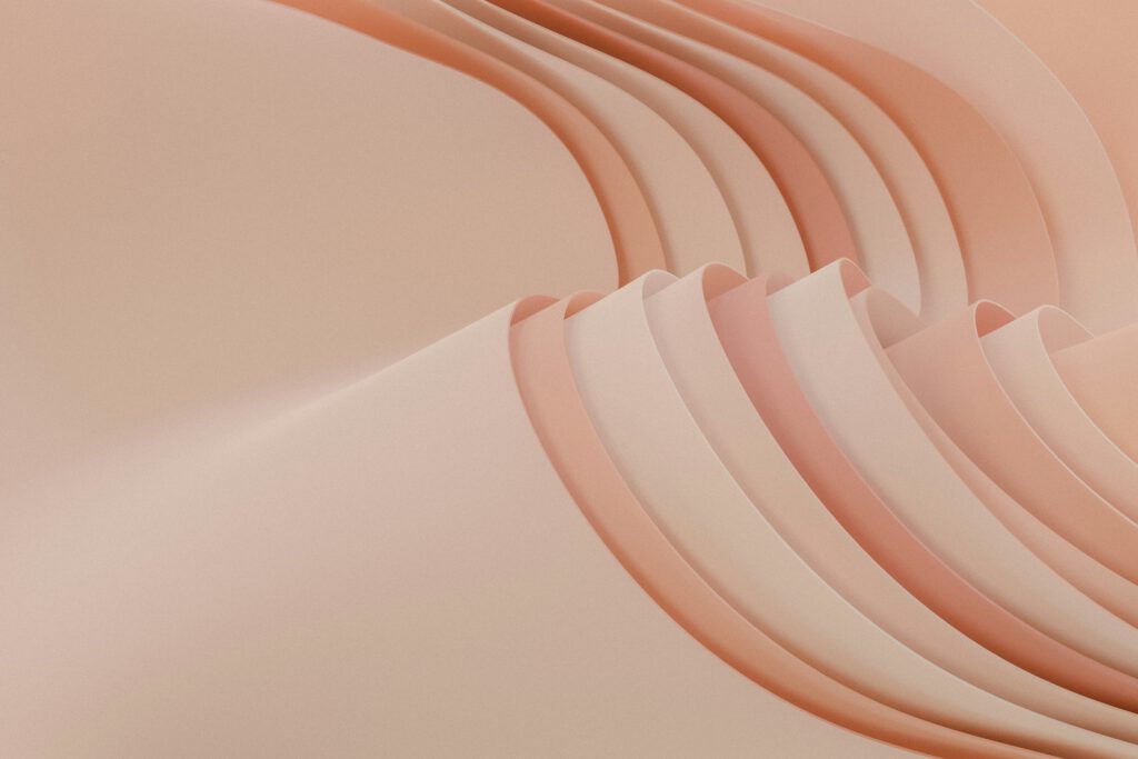 Curved lines and shapes in peach and coral create an abstract background, evoking raw craft materials.