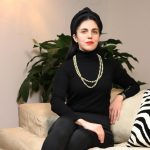 The image features Alessandra Guerrieri the founder of AGpress Sustainable Press Office in a total black attire sat in on a off-white sofa.